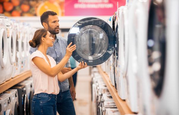 man and woman shopping for washing machine