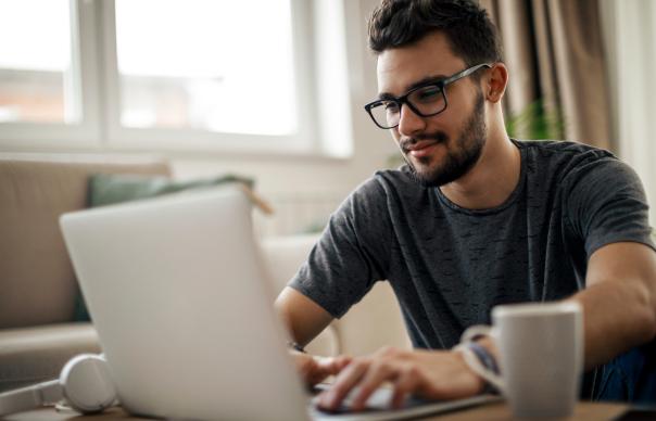 man typing on laptop